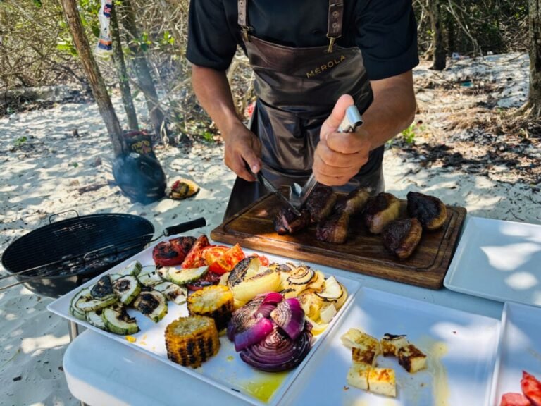 Chef serving grilled food on a beach in Guaratiba, Rio de Janeiro