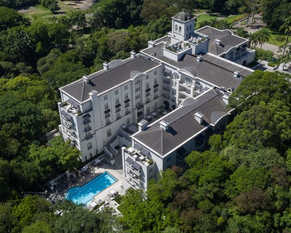 Pool and Atlantic forest canopy view at Palácio Tangará in São Paulo